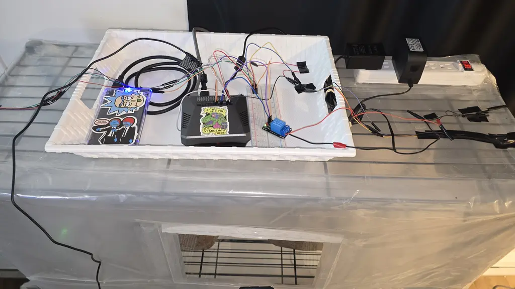 Raspberry Pi with breadboard and relay board wired to sensors and actuator