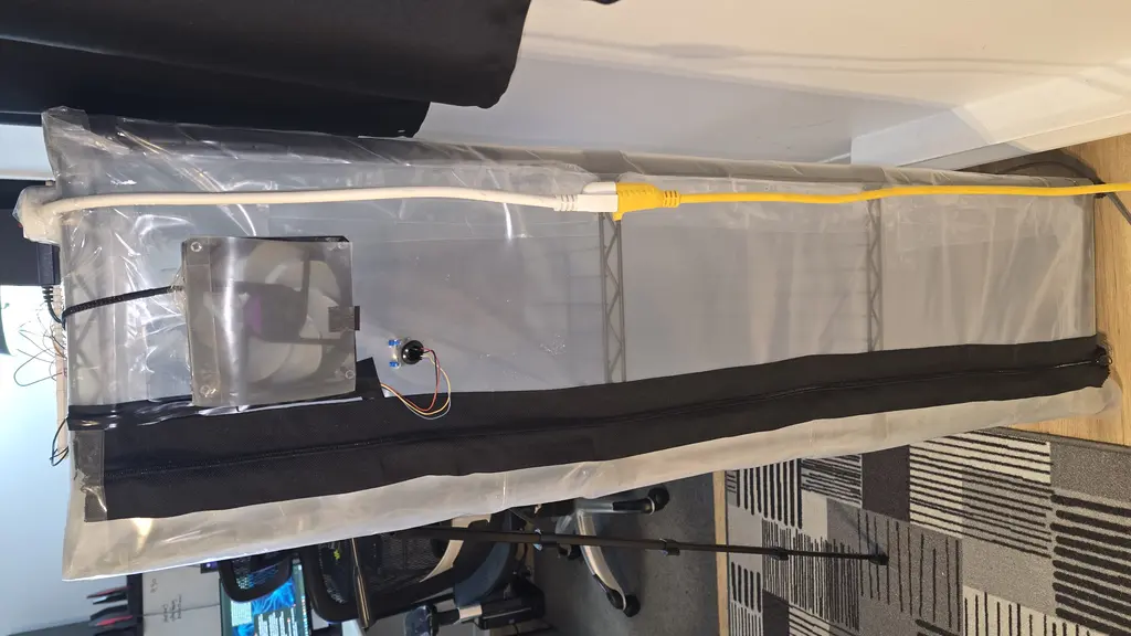 Side view of the grow tent showing the exhaust fan mounted at the top, power and network routing